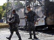 Soldiers in Front of Burned Bus