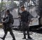 Soldiers in Front of Burned Bus